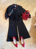 Black sweater with red and green trim